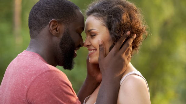 istock Overjoyed lovers hug one another delightfully, look at each other sensually 1004734908