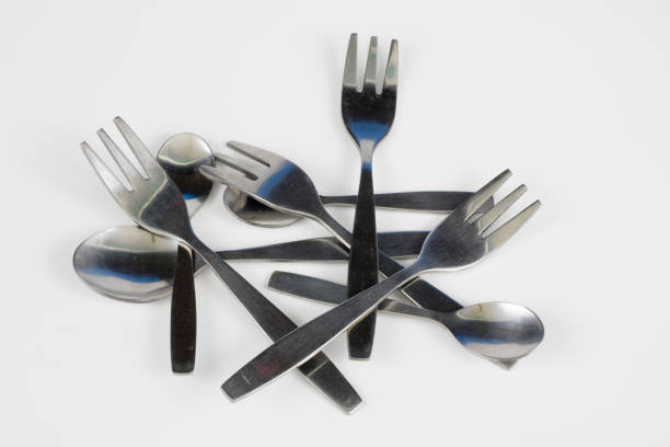 istock Cutlery arranged on a white kitchen table. Accessories for kitchen and restaurant use. White background. 1004735172