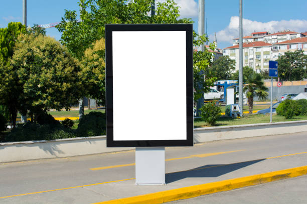 istock Blank white mock up of vertical light box billboard at bus stop station 1004737280