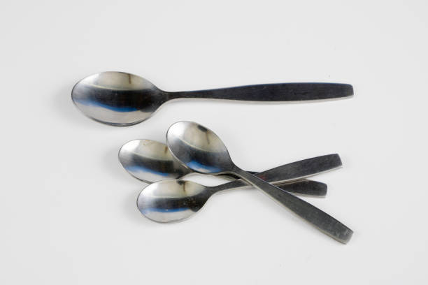 istock Cutlery arranged on a white kitchen table. Accessories for kitchen and restaurant use. White background. 1004737290