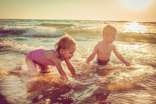 Happy children running by the sea