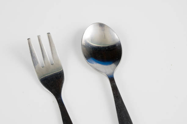 istock Cutlery arranged on a white kitchen table. Accessories for kitchen and restaurant use. White background. 1004737462