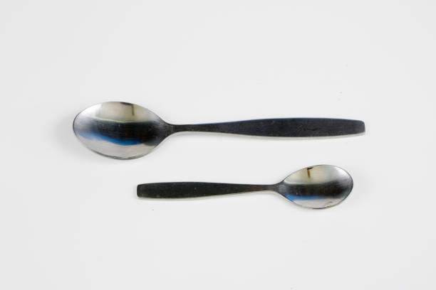 istock Cutlery arranged on a white kitchen table. Accessories for kitchen and restaurant use. White background. 1004737534