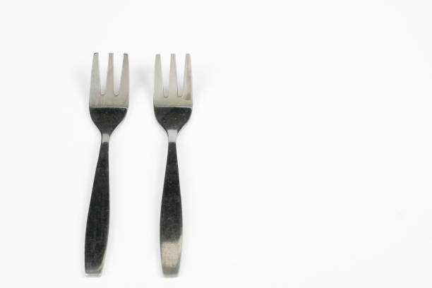istock Cutlery arranged on a white kitchen table. Accessories for kitchen and restaurant use. White background. 1004737738