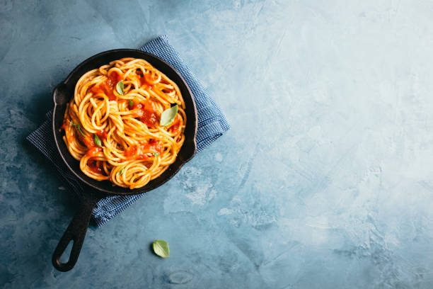istock Italian pasta with tomato sauce in pan 1004740340