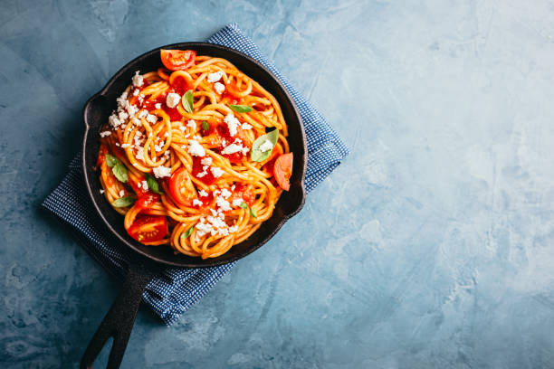 istock Italian pasta with tomato sauce in pan 1004740510