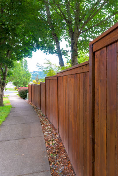 Wooden Fence along suburban neighborhood sidewalk stock photo