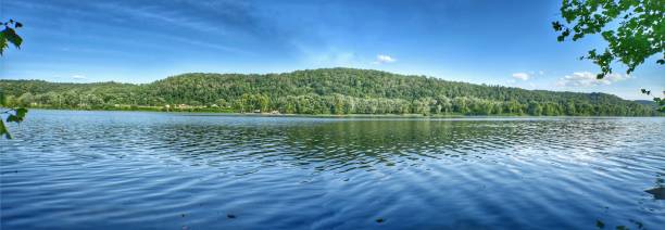 Panoramic mountain trees, sisterville Ohio river Panoramic riverbank mountain trees blue green water reflection ohio river photos stock pictures, royalty-free photos & images