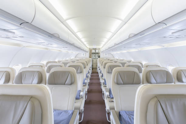 istock Interior of empty ready to fly airliner cabin with rows of seats. 1004771938