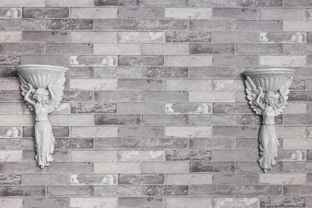 istock Old vintage statue on gray brick wall background and texture. 1004775786