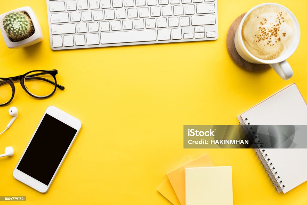 Top view of office desk table with modern accessories,supplies on color background. Top view of office desk table with modern accessories,supplies on color background.flat lay design.business concepts ideas Desk Stock Photo