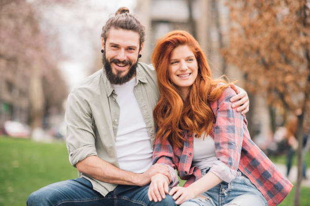 istock Beautiful young couple hugging outdoors 1004779330