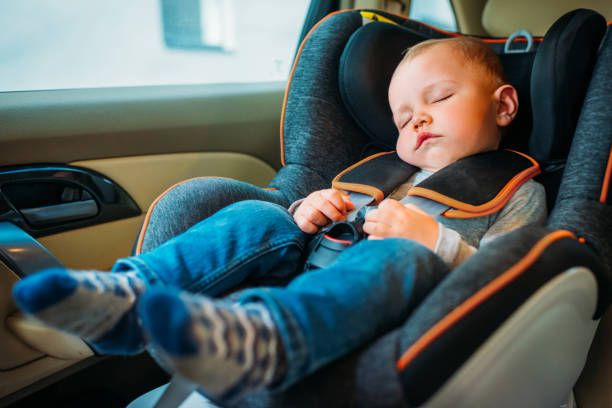 cute little baby sleeping in child safety seat in car cute little baby sleeping in child safety seat in car baby carrier stock pictures, royalty-free photos & images