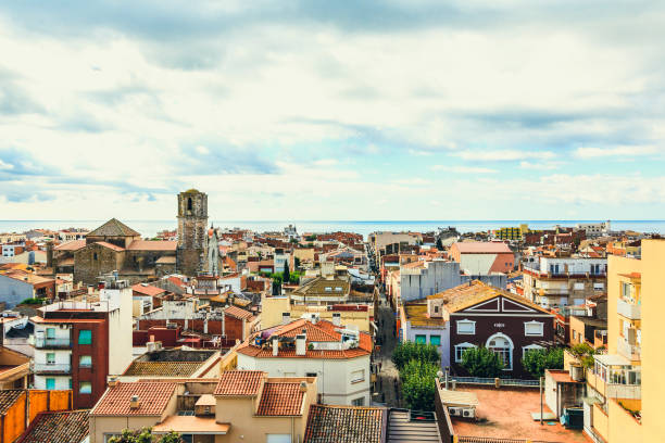 View of the old spanish town Malgrat de Mar, roof tops with red tile, cityscape on the coast of Mediterranean sea, Costa Brava, Maresme, province of Barcelona, Catalonia, Spain. Travel and vacation, touristic place. Top view.