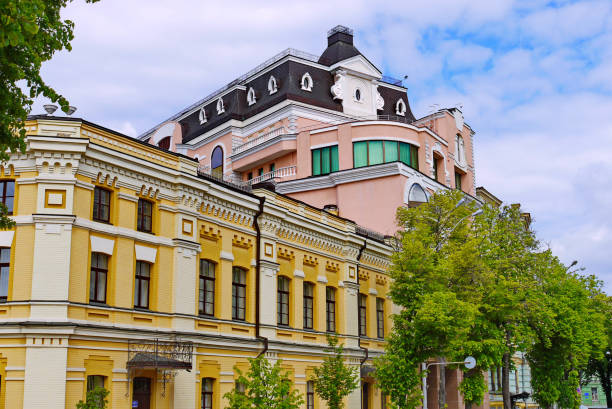 istock Street with several beautiful modern buildings against a blue sky with small white clouds 1004799994