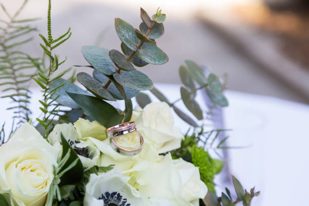 istock Bouquet of roses and rings lying on table 1004801342