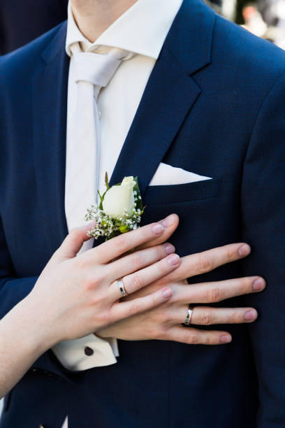 istock Groom and brides hands with rings close-up 1004801350
