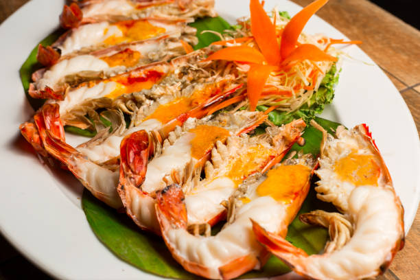 istock Grilled shrimp with Shrimp Paste in white dish showing the delicious Shrimp Paste inside its shell. Thai seafood. 1004806738