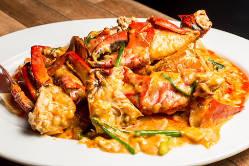 Stir-Fried Sea Crab with Curry Powder Sauce, Milk and Eggs on white dish. A popular Thai-Chinese seafood