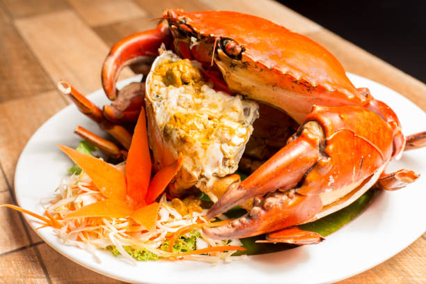 istock Steamed crab or Boiled crab fresh with crab's spawn in white dish showing the delicious crab's eggs inside its shell. Thai seafood. 1004807210