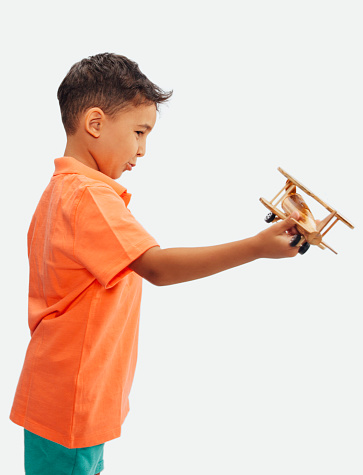 Portrait of child flying airplane