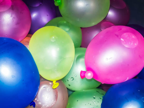 Kids Playing Water Balloons Battle in Summer