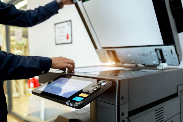 istock Business man Hand press button on panel of printer, printer scanner laser office copy machine supplies start concept. 1004833542