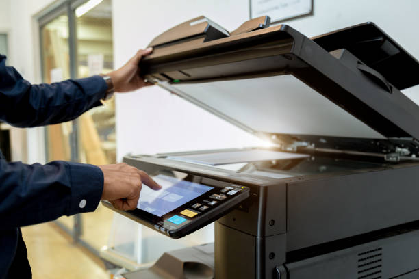 istock Business man Hand press button on panel of printer, printer scanner laser office copy machine supplies start concept. 1004835720