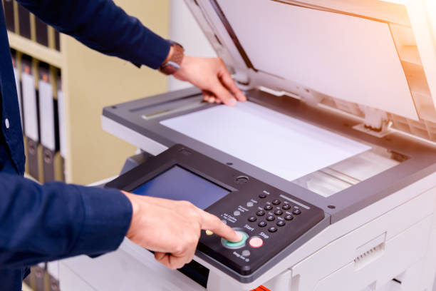 istock Close-up business man Hand press button on panel of printer, printer scanner laser office copy machine supplies start concept. 1004838750