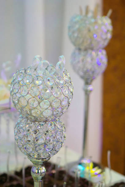 The crystal candle holder with candles in white.