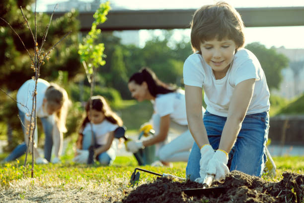 istock Serious boy preparing soil for gardening 1004853102