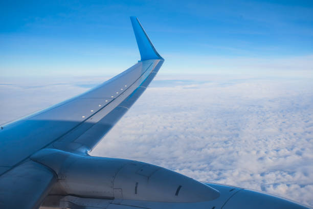istock view to the airplane wing above a clouds 1004856606