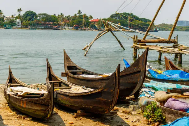 Traditional dugout fishing canoes on the shores on Kochi, India.