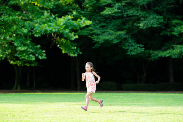 istock Girl playing on the lawn 1004859524