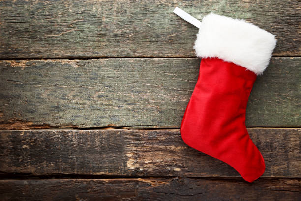 istock Christmas stocking on wooden table 1004868282