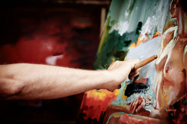 istock Artist working on big painting 1004868366