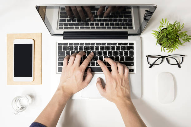 istock Man is typing on his laptop. Top view, flat lay. 1004871328