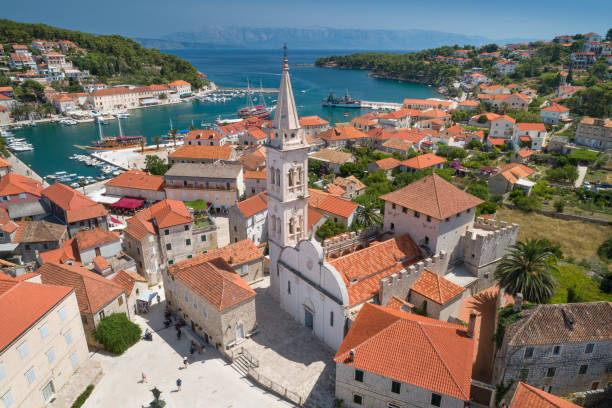 Jesla with St. Mary's Church, Hvar, Croatia Unique aerial of the beautiful croatian harbor town Jesla with its famous St. Mary’s Church. Located on the Island Hvar in the Adriatic Sea. Croatia. You can even see the Croatian Mainland in back. Converted from RAW. jelsa stock pictures, royalty-free photos & images