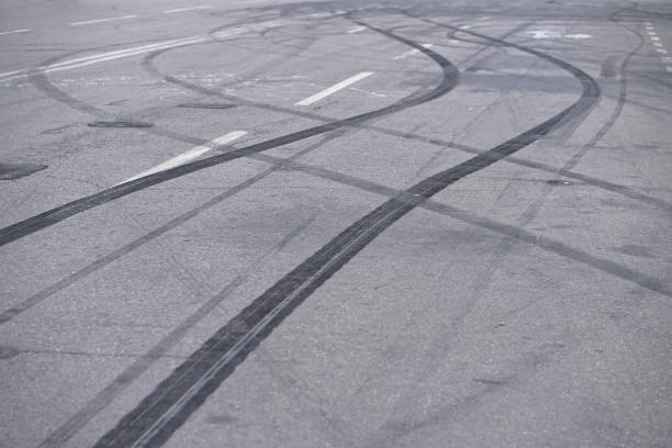 Abstract of Black tire wheels caused by Drift car on the road. Braking at a pedestrian crossing and a road with markings. Stock photo for design stock photo