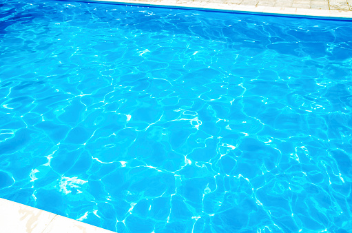 Swimming pool side water surface in sunlight