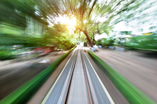 Blurred railway track and city street