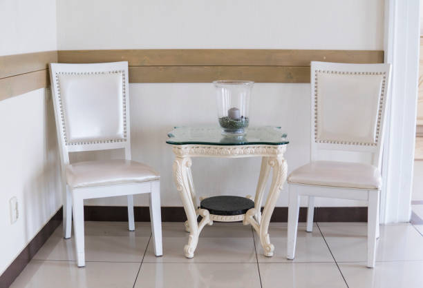 istock Vintage white chair and table with a candle. 1004889900
