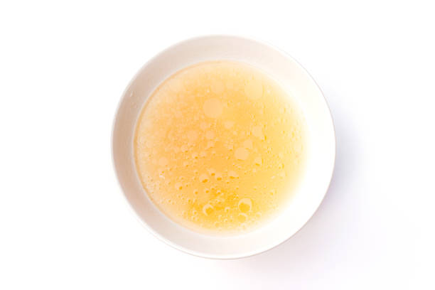 Bowl of chicken broth isolated on white background.