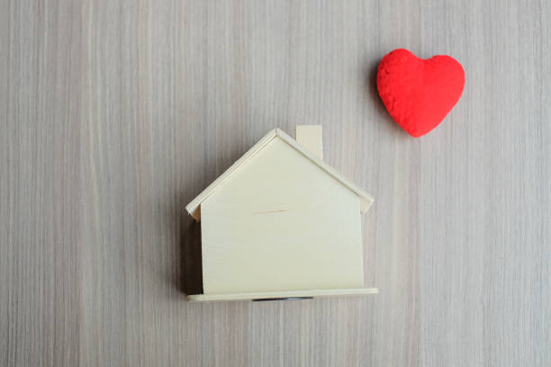 istock Directly Above Shot Of Model Home And Red Heart Shape On Table 1004908504