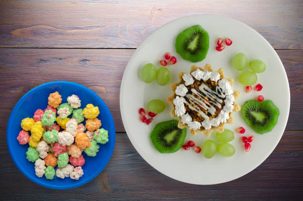 istock dessert of cake and fruit (grapes, kiwi, pomegranate) on a wooden 1004922276