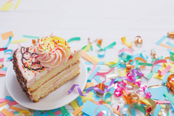 istock birthday cake and  decoration on white wooden background 1004922510