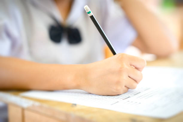 istock Examination in school concept. student writing answer the question of multiple choice test 1004923028