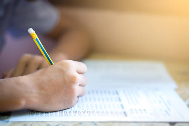 istock Examination in school concept. student writing answer the question of multiple choice test 1004923096