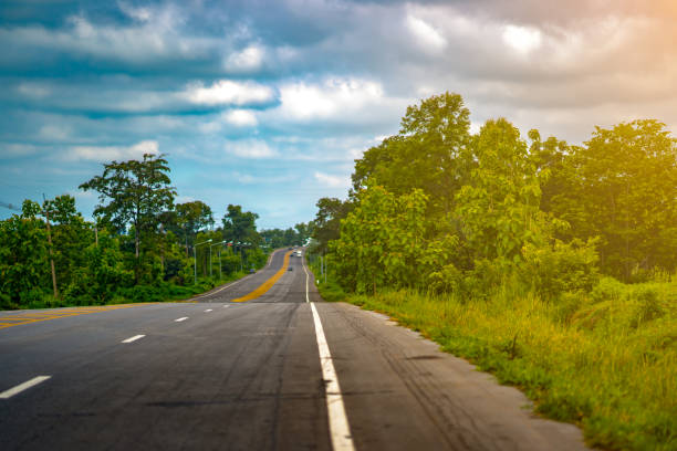 istock Long road highway pass forest on blue sky and cloud 1004923632