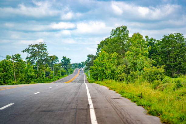 istock Long road highway pass forest on blue sky and cloud 1004923758